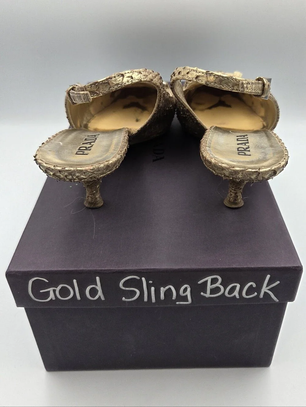 Pre- owned Prada snakeskin braided accents slingback pumps in a metallic gold
